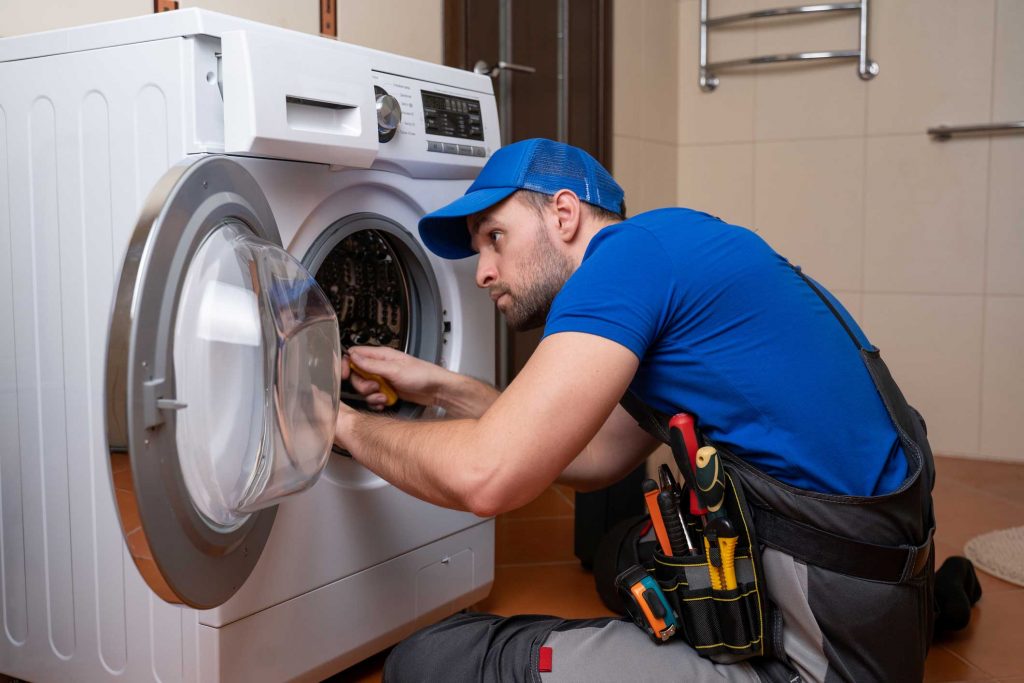 a technician repairing a washer and dryer repair mount pleasant