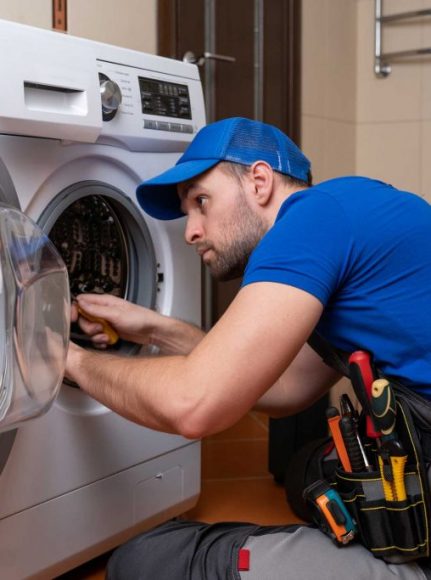 a technician repairing a washer and dryer repair mount pleasant